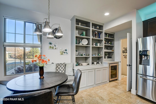 dining area with plenty of natural light and beverage cooler