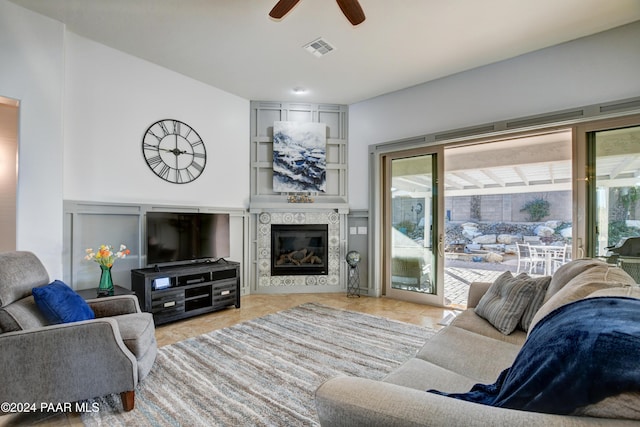 living room with ceiling fan and light tile patterned flooring