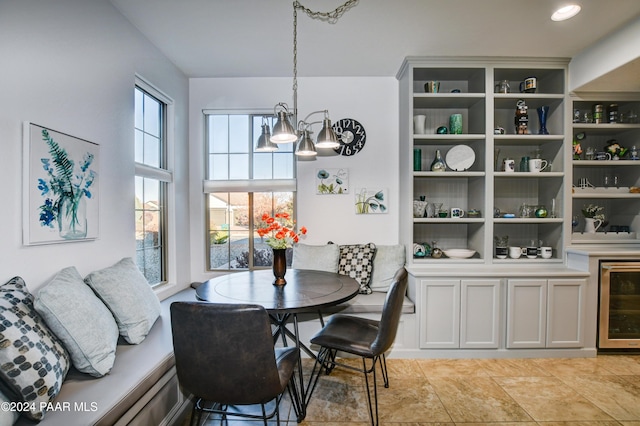 dining area with a notable chandelier, breakfast area, and beverage cooler