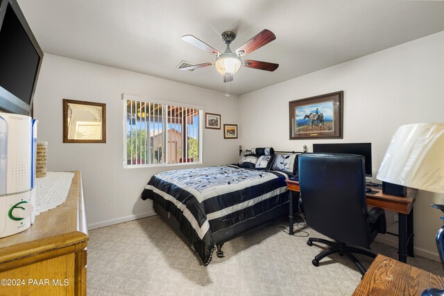 bedroom with ceiling fan and light carpet