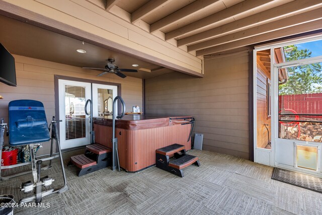 view of patio / terrace featuring ceiling fan and a hot tub