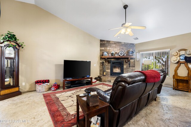 living room featuring a fireplace, ceiling fan, and lofted ceiling