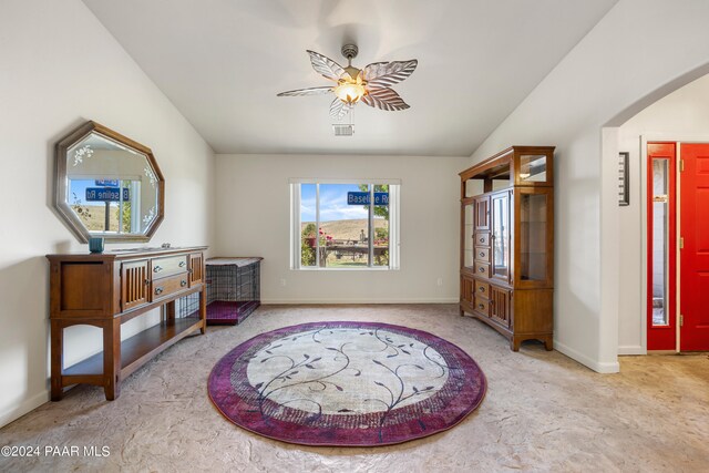 living area with ceiling fan and lofted ceiling