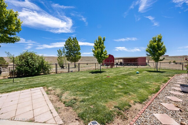 view of yard with a rural view and a storage unit