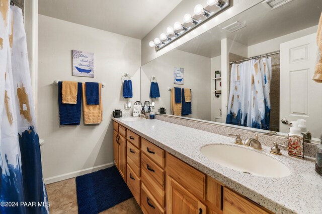 bathroom with tile patterned flooring and vanity