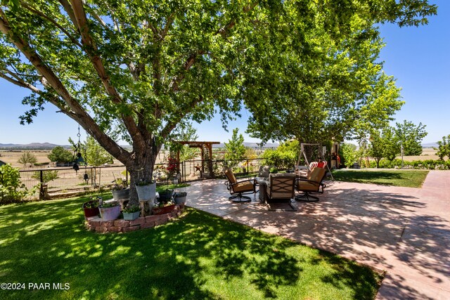 view of yard with a rural view and a patio area