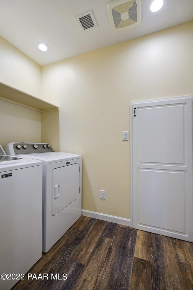 laundry area featuring laundry area, visible vents, dark wood finished floors, and washing machine and clothes dryer