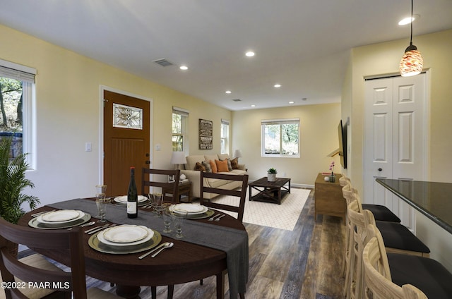 dining space with dark wood-style floors, visible vents, and recessed lighting