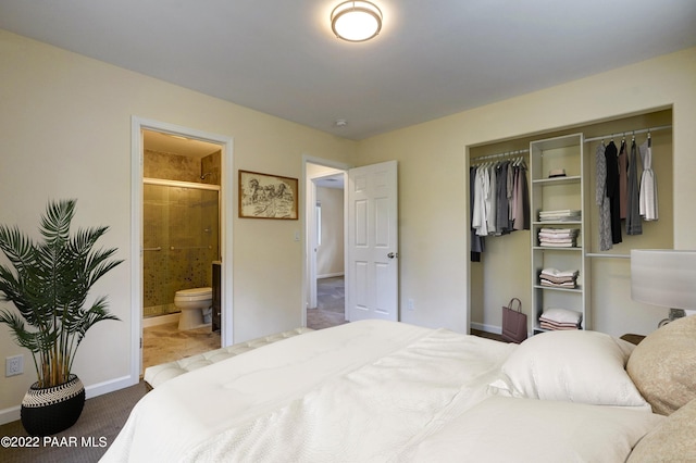 bedroom featuring a closet, ensuite bath, and baseboards