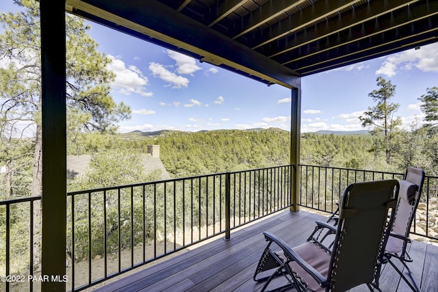 wooden terrace with a view of trees