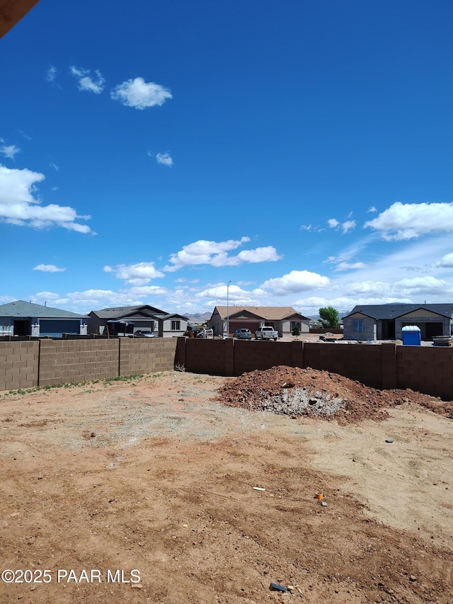 view of yard featuring a residential view and fence