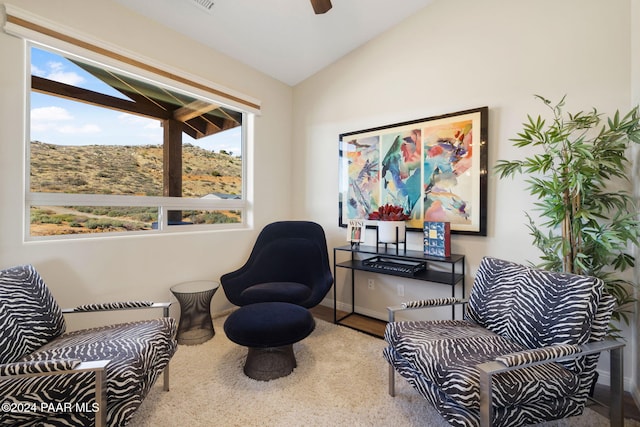 living area with wood-type flooring and vaulted ceiling