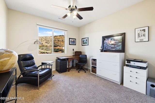 carpeted office space featuring ceiling fan