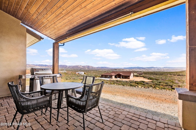 view of patio with a mountain view and grilling area