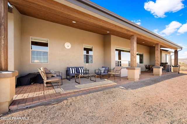 back of property featuring an outdoor hangout area and a patio