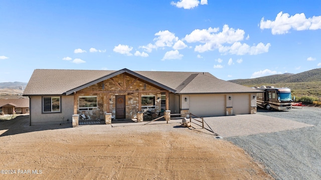 ranch-style home featuring a mountain view and a garage