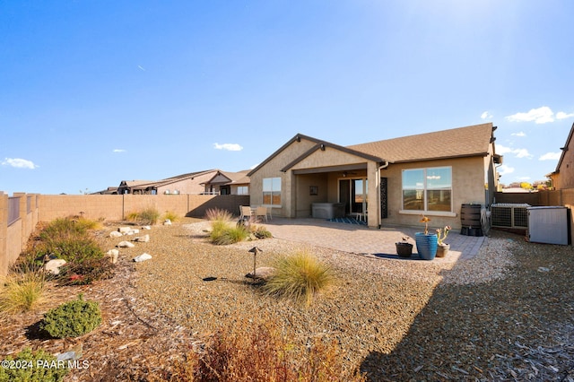 back of property with a patio