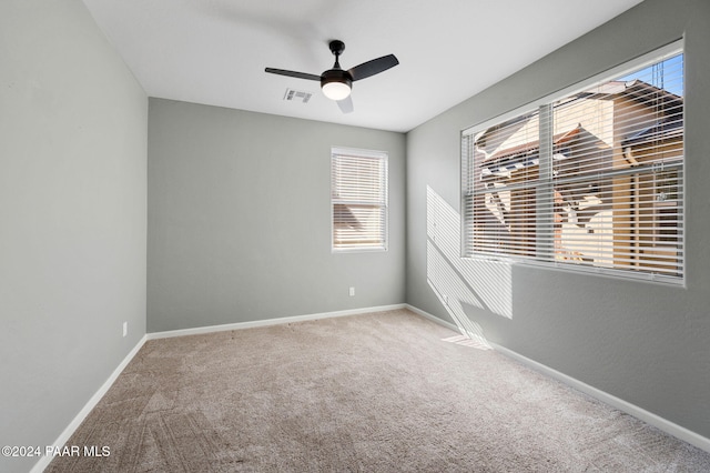 spare room with ceiling fan and carpet floors