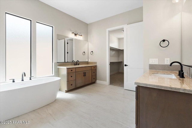1052 N Cloud Cliff Pass, Prescott Valley, AZ 86314 - full bathroom with two vanities, a freestanding bath, and baseboards