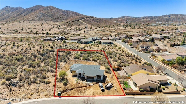 1052 N Cloud Cliff Pass, Prescott Valley, AZ 86314 - aerial view of residential area featuring a mountain backdrop, property boundaries highlighted, and a desert landscape