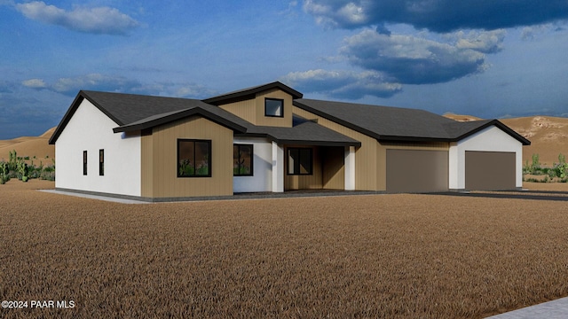 view of front of property with a mountain view and a garage