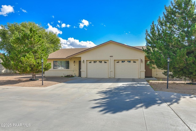 ranch-style house with an attached garage, stucco siding, and concrete driveway