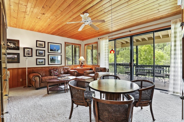 sunroom / solarium featuring wood ceiling, ceiling fan, and a healthy amount of sunlight