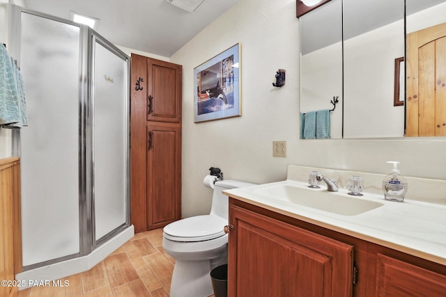 bathroom with vanity, toilet, and an enclosed shower