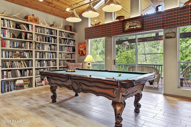 rec room with a towering ceiling, plenty of natural light, pool table, and wooden ceiling