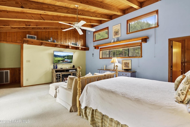 carpeted bedroom with wood ceiling, ceiling fan, and beamed ceiling