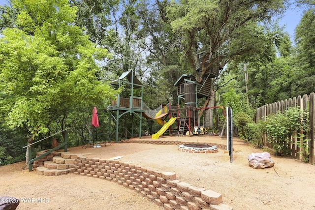 view of playground with an outdoor fire pit