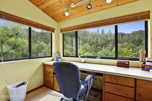 office space featuring lofted ceiling, wood ceiling, a wealth of natural light, and built in desk