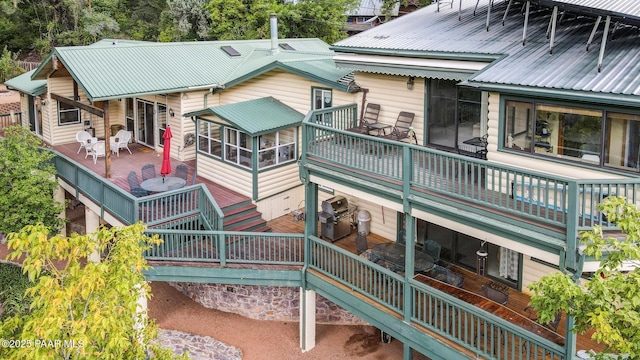 back of house featuring a sunroom