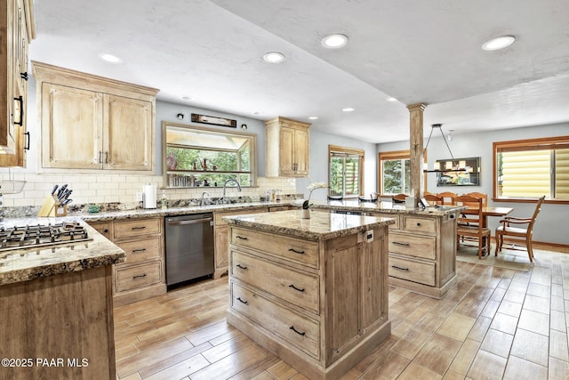 kitchen with decorative light fixtures, a center island, stainless steel appliances, decorative columns, and decorative backsplash