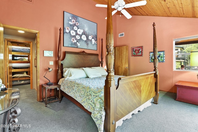 carpeted bedroom with lofted ceiling, wood ceiling, and ceiling fan