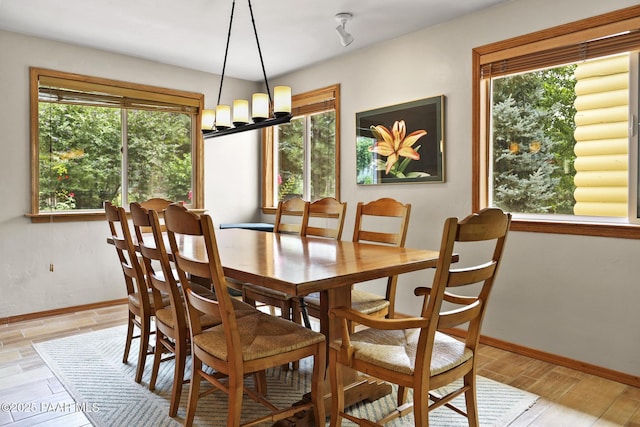 dining room featuring a chandelier and a healthy amount of sunlight