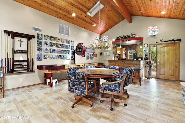 dining room featuring wood ceiling, a skylight, and high vaulted ceiling