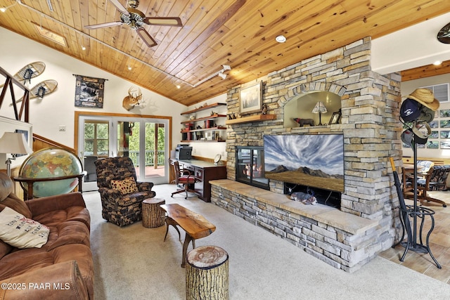 living room featuring vaulted ceiling, a stone fireplace, ceiling fan, light carpet, and wooden ceiling