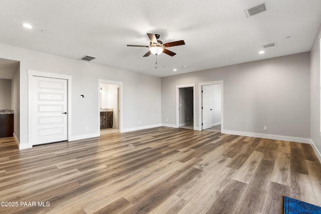 unfurnished bedroom with recessed lighting, wood finished floors, visible vents, and baseboards