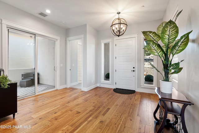 foyer featuring visible vents, a notable chandelier, recessed lighting, light wood finished floors, and baseboards