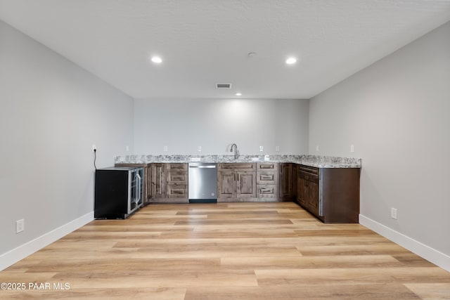 kitchen with visible vents, stainless steel dishwasher, recessed lighting, light wood-style floors, and baseboards