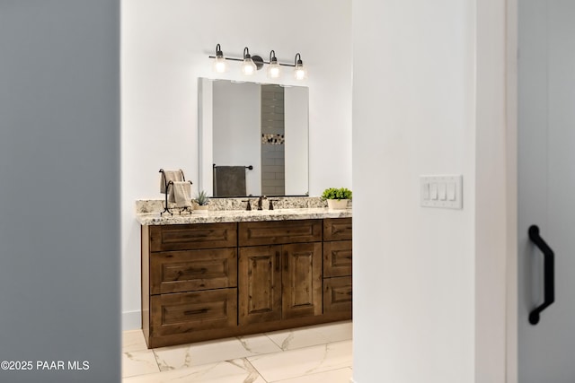 bathroom featuring marble finish floor and vanity