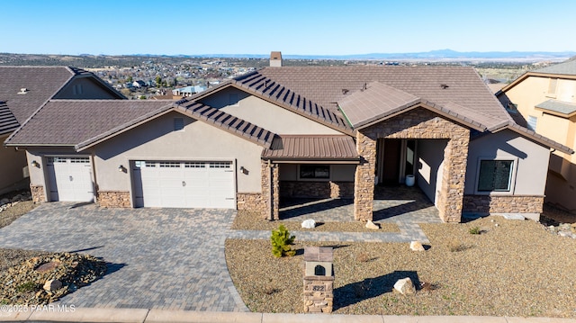 view of front of home with a garage and stone siding