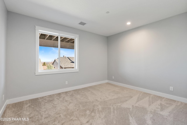 unfurnished room featuring baseboards, visible vents, and carpet floors