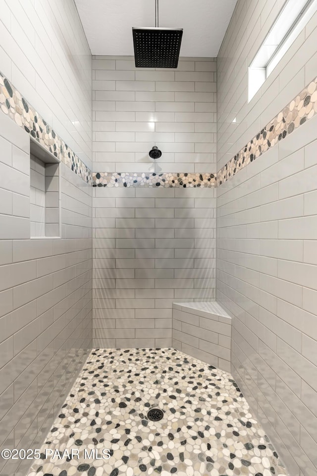 full bath featuring tiled shower