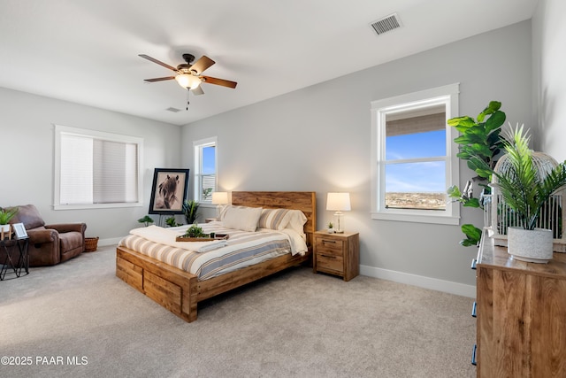 bedroom featuring visible vents, multiple windows, baseboards, and carpet floors