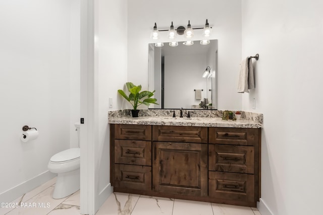 bathroom featuring vanity, toilet, baseboards, and marble finish floor