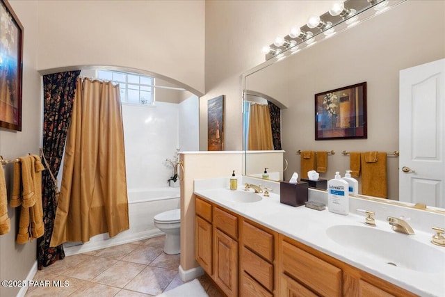 bathroom featuring double vanity, tile patterned flooring, a sink, and toilet