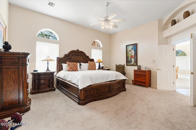 bedroom featuring light carpet, ceiling fan, and visible vents