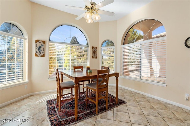 dining area featuring light tile patterned floors, baseboards, and a ceiling fan